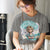 Person wearing a t-shirt with a graphic design and text