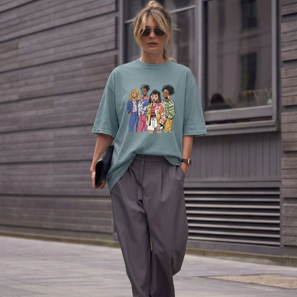 Person wearing a ice-blue t-shirt with a graphic design, standing outdoors.