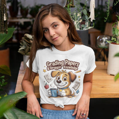 Person wearing a white t-shirt with a cartoon dog graphic and text in an indoor setting.