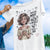 White t-shirt with a graphic of a woman holding a mug and text, against a blue sky background.