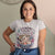Person wearing a t-shirt with a graphic design and text.