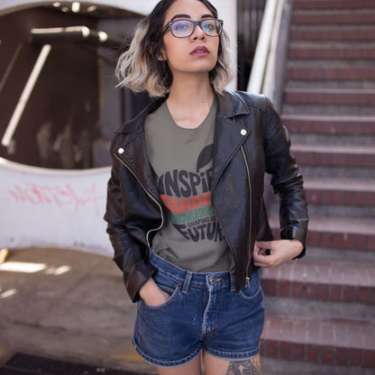 Woman wearing a leather jacket and graphic t-shirt standing in an urban setting.