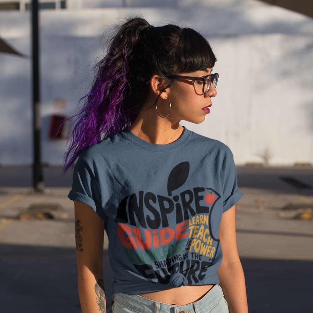 Person wearing a blue t-shirt with text outdoors