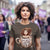 Woman wearing a t-shirt with a graphic design of a woman in a coffee cup and text 'Don't ask me anything before 2 cups'.