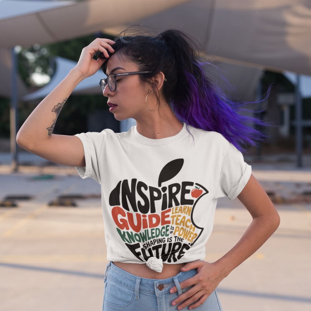 Person wearing a white t-shirt with colorful text and graphics, standing outdoors.