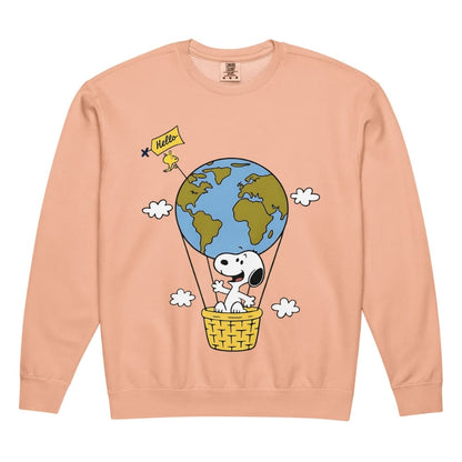 Peach-colored sweatshirt with a cartoon design of a dog in a hot air balloon with the Earth, on a peach background.