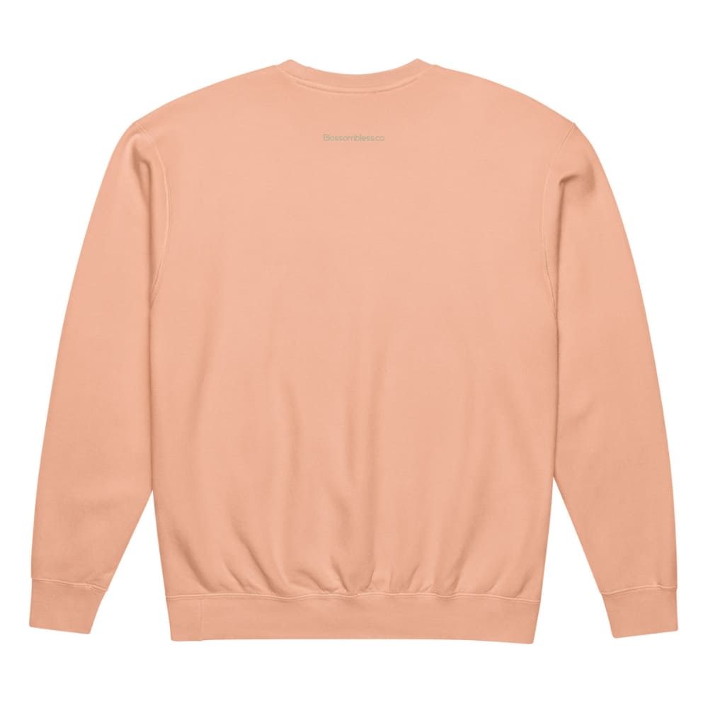 Back view of a peach-colored sweatshirt on a white background