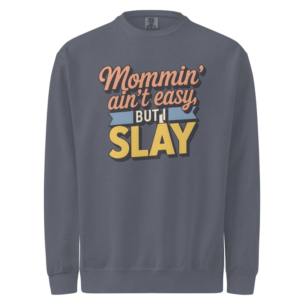 “Mommin' Ain’t Easy But I Slay” retro-style DTG printed design in peach, blue, and yellow on vintage garment-dyed fleece sweatshirt