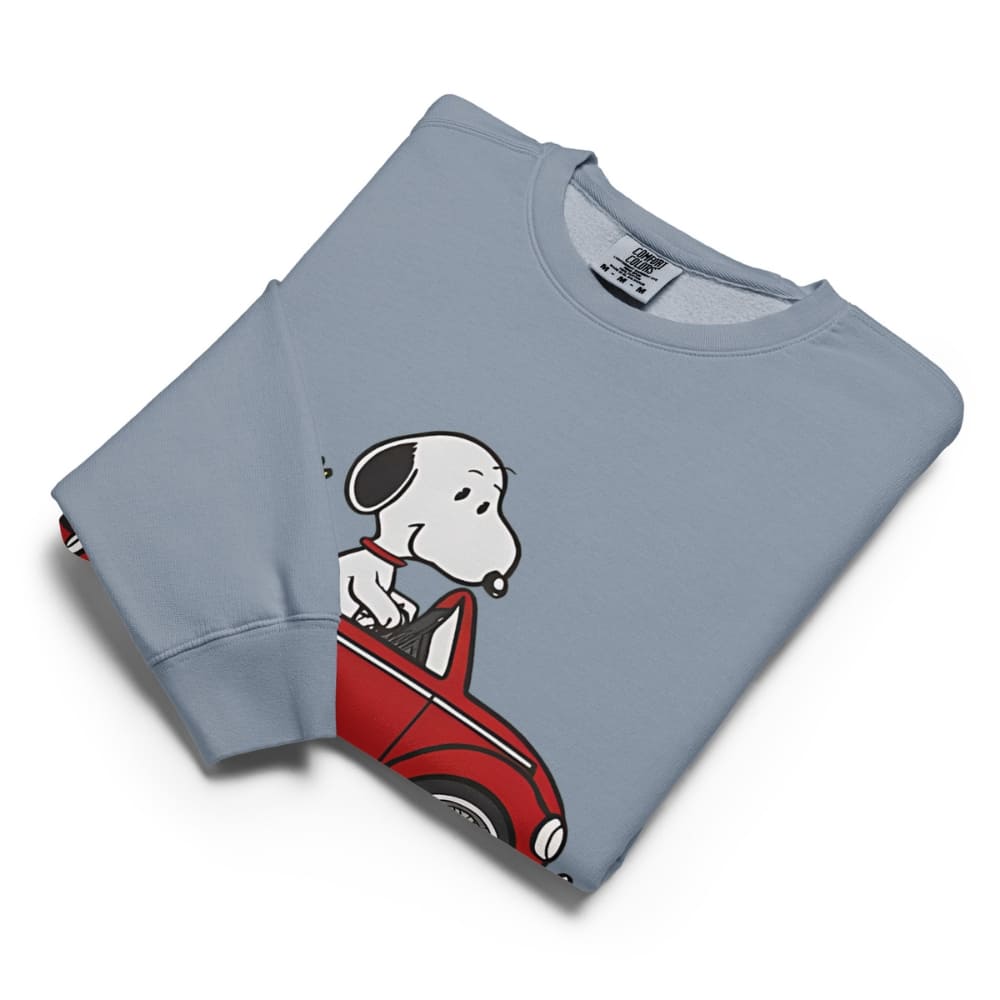 Folded blue sweatshirt with a cartoon dog design on a white background