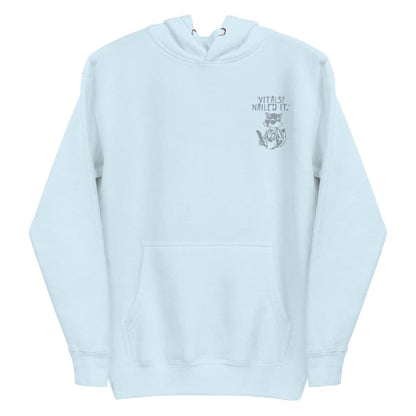 Raccoon nurse graphic wearing scrubs and sunglasses holding a clipboard under the quote “Vitals? Nailed It.” – printed on a black Cotton Heritage hoodie