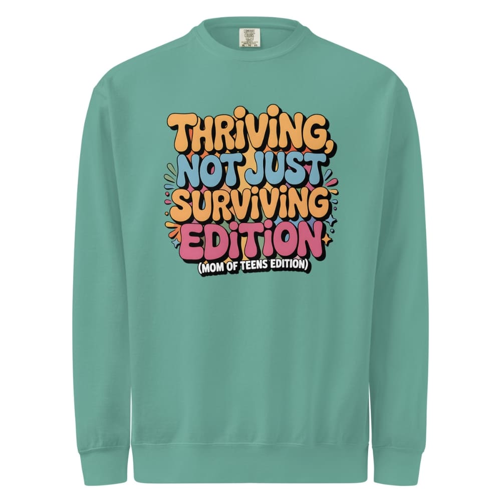 Teal sweatshirt with colorful text design on a white background