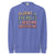 Blue sweatshirt with colorful text 'Fluent in Eye Rolls & Bedtime Negotiations' on a white background