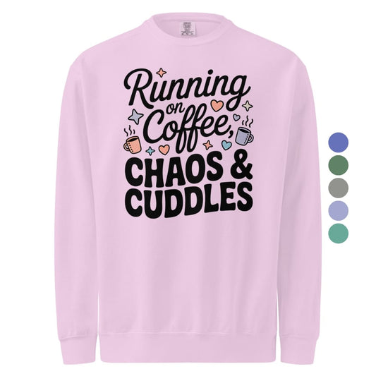 Pink sweatshirt with 'Running on Coffee, Chaos & Cuddles' text and graphics on a white background.