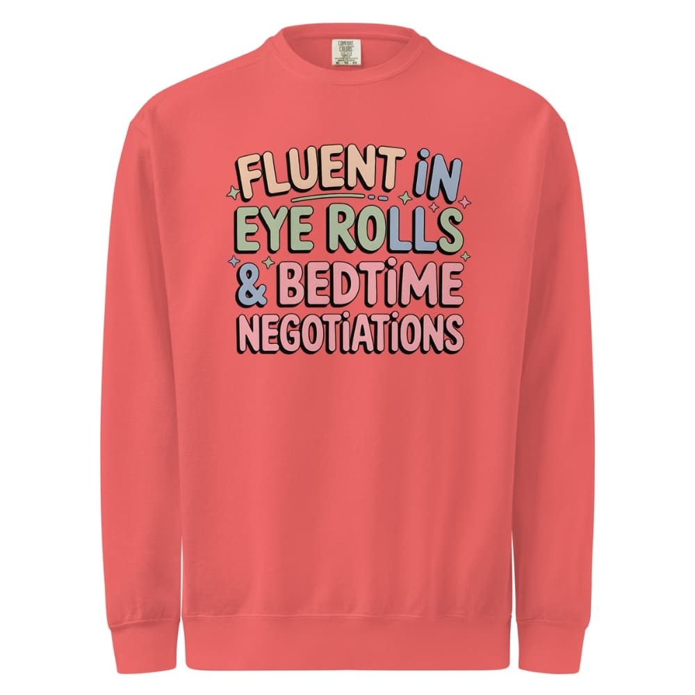 Red sweatshirt with colorful text 'FLUENT IN EYE ROLLS & BEDTIME NEGOTIATIONS' on a white background