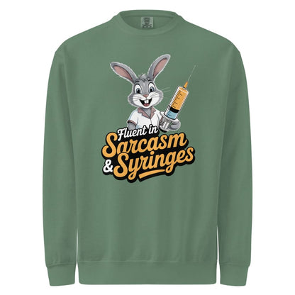 Green sweatshirt with cartoon character holding a syringe and text 'Fluent in Sarcasm & Syringes' on a white background