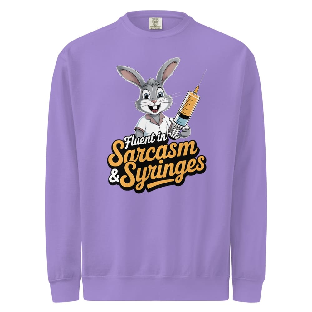 Purple sweatshirt with cartoon character holding a syringe and text 'Fluent in Sarcasm & Syringes' on a white background