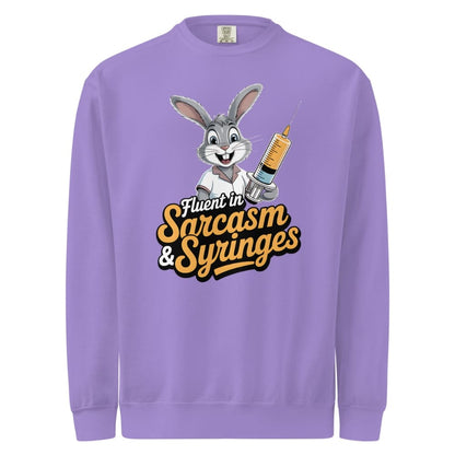 Purple sweatshirt with cartoon character holding a syringe and text 'Fluent in Sarcasm & Syringes' on a white background