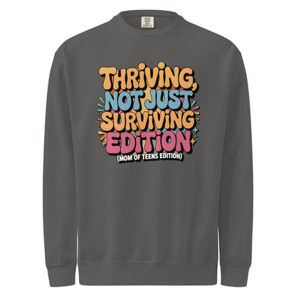 Gray sweatshirt with colorful text design on a white background