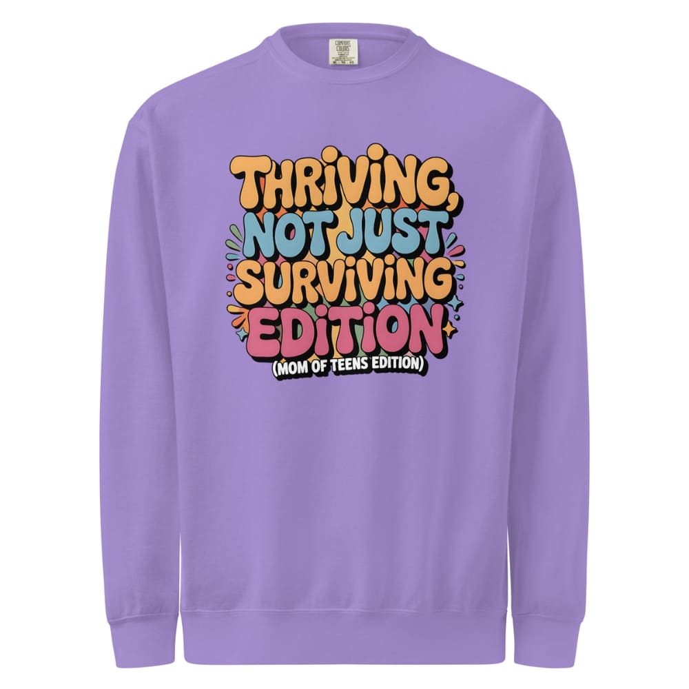 Purple sweatshirt with colorful text design on a white background