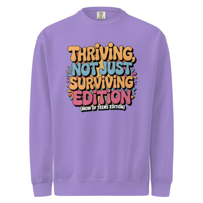 Purple sweatshirt with colorful text design on a white background