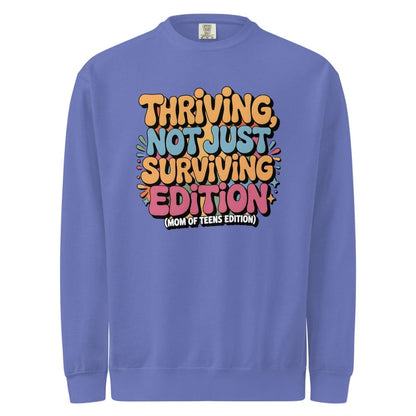 Purple sweatshirt with colorful text design on a white background