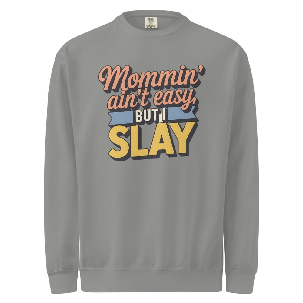 “Mommin' Ain’t Easy But I Slay” retro-style DTG printed design in peach, blue, and yellow on vintage garment-dyed fleece sweatshirt