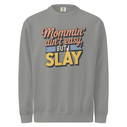 “Mommin' Ain’t Easy But I Slay” retro-style DTG printed design in peach, blue, and yellow on vintage garment-dyed fleece sweatshirt