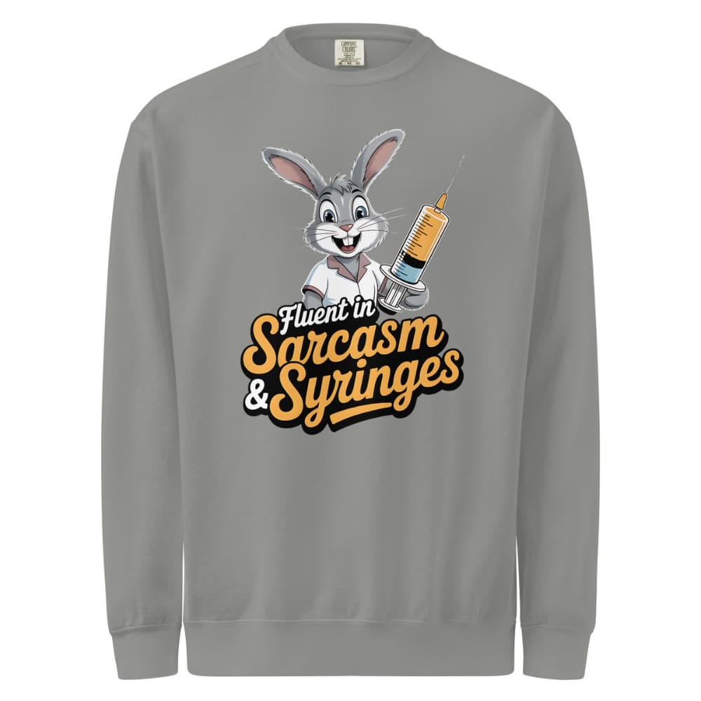 Gray sweatshirt with cartoon character holding a syringe and text 'Fluent in Sarcasm & Syringes' on a white background