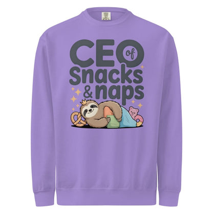 "CEO of Snacks & Naps" printed sweatshirt featuring a sloth in a crown surrounded by pretzels and plushies on vintage-washed cotton fleece