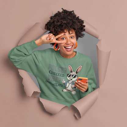 Person wearing a green sweatshirt with a cartoon character and text, standing through a torn paper background.