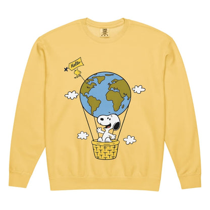 Yellow sweatshirt with a cartoon design of a dog in a hot air balloon with the Earth, on a white background.