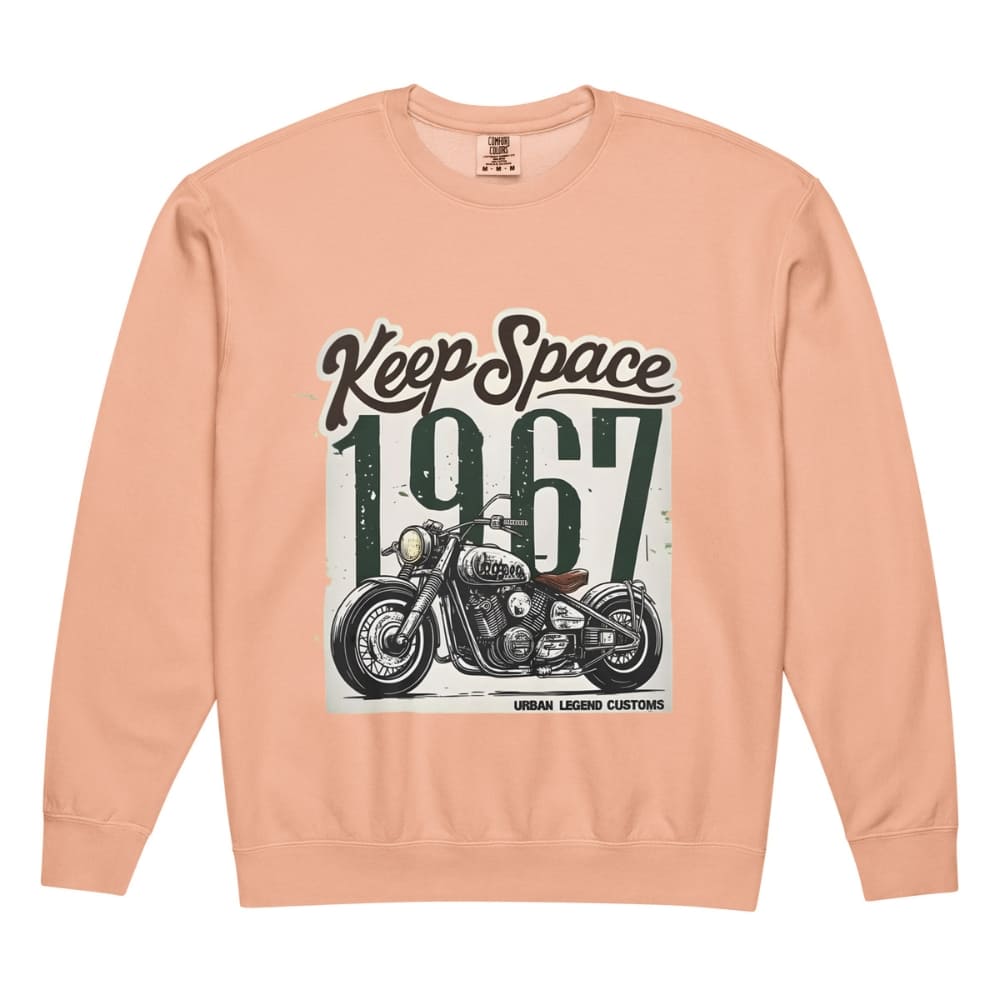 Peach-colored sweatshirt with motorcycle graphic and text 'Keep Space 1967' on a white background