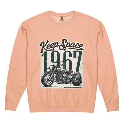 Peach-colored sweatshirt with motorcycle graphic and text 'Keep Space 1967' on a white background
