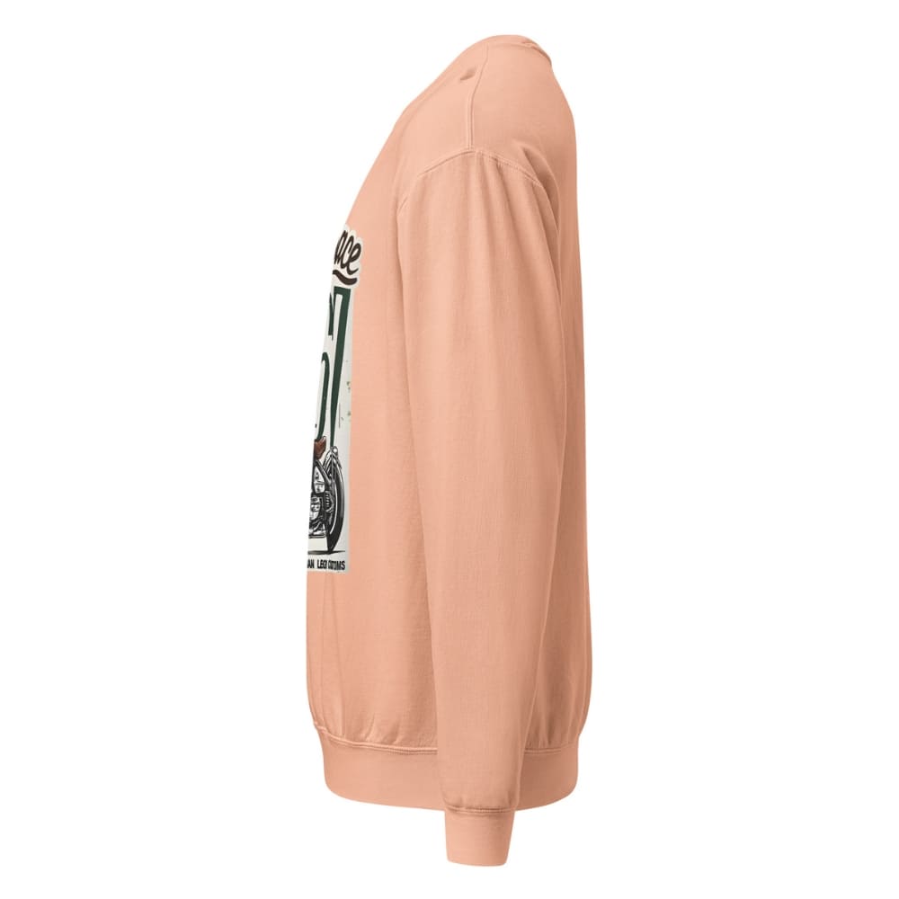 Peach-colored sweatshirt with a graphic on the sleeve against a white background