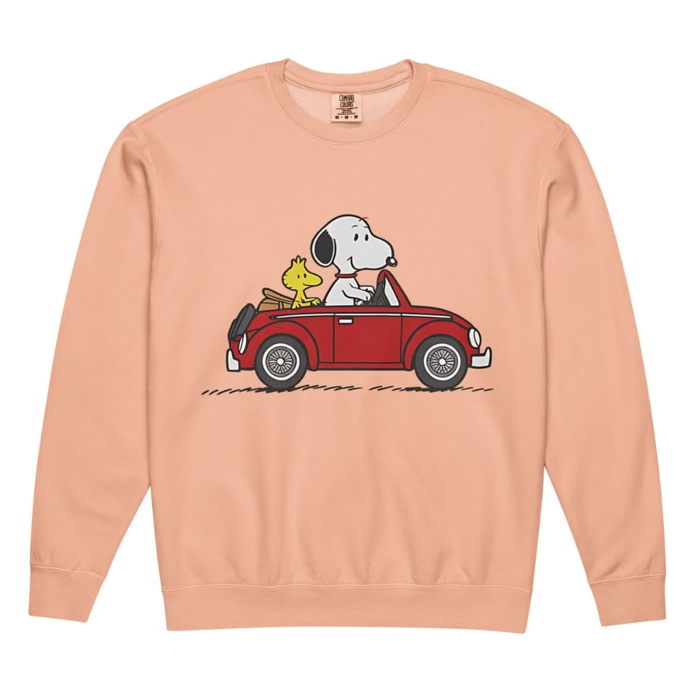 Snoopy and Woodstock in a car on a peach-colored sweatshirt