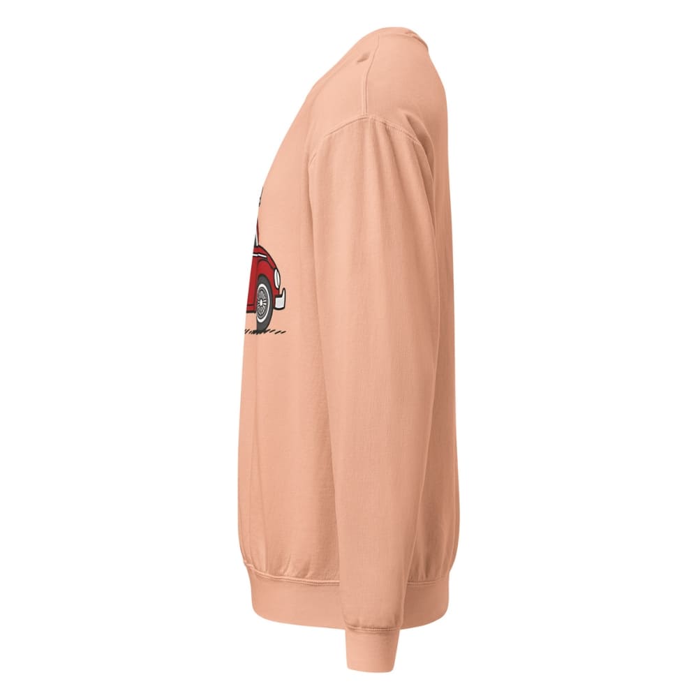Peach-colored sweatshirt with a red car graphic on the sleeve against a white background