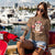 Cute cartoon owl cheerleader holding a pom-pom and clipboard, wearing a red cap with the quote “Behind Every Great Swing Is a Loud Mom” – featured on garment-dyed heavyweight cotton tee