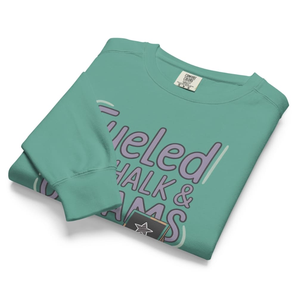 Fueled by Chalk & Dreams printed design on a vintage-style garment-dyed sweatshirt with chalkboard illustration – soft fleece ideal for teachers