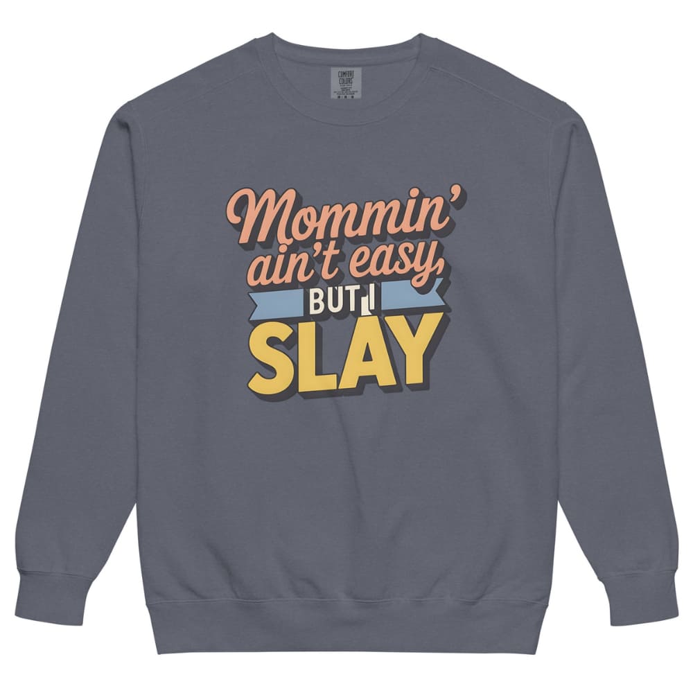 “Mommin' Ain’t Easy But I Slay” retro-style DTG printed design in peach, blue, and yellow on vintage garment-dyed fleece sweatshirt
