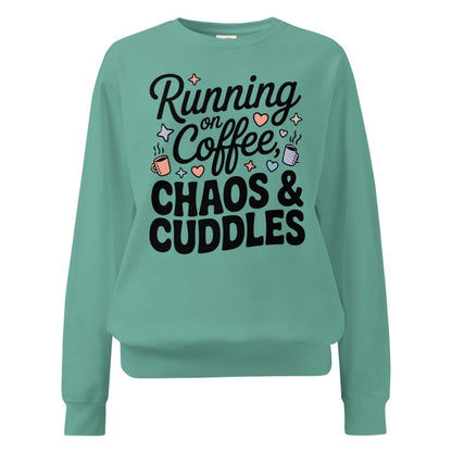 Teal sweatshirt with text 'Running on Coffee, Chaos & Cuddles' on a white background