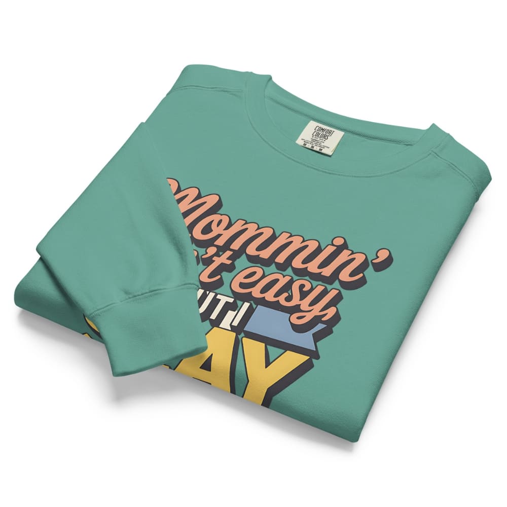 “Mommin' Ain’t Easy But I Slay” retro-style DTG printed design in peach, blue, and yellow on vintage garment-dyed fleece sweatshirt