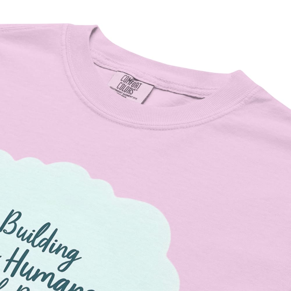 Illustrated t-shirt design with the quote "Building Tiny Humans with Big Dreams" surrounded by a family parenting scene