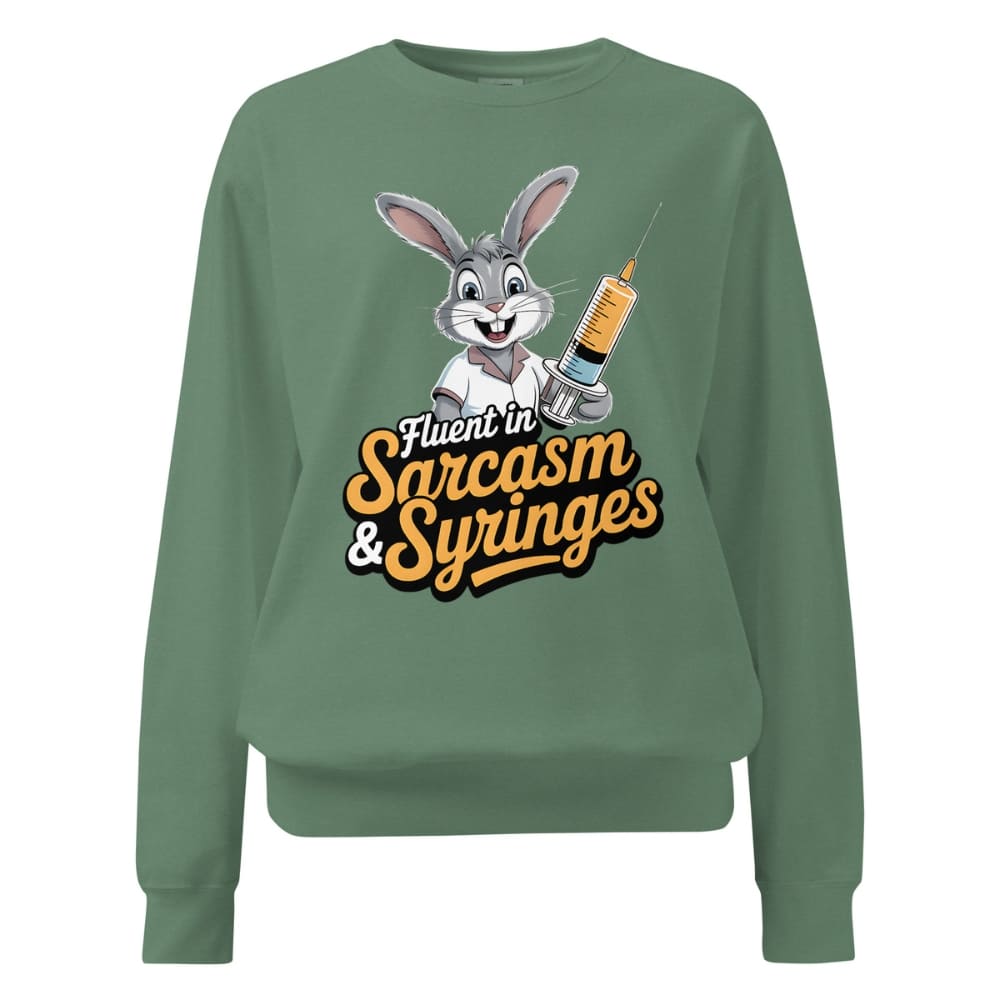 Green sweatshirt with cartoon character and text ' Fluent in Sarcasm & Syringes' on a white background