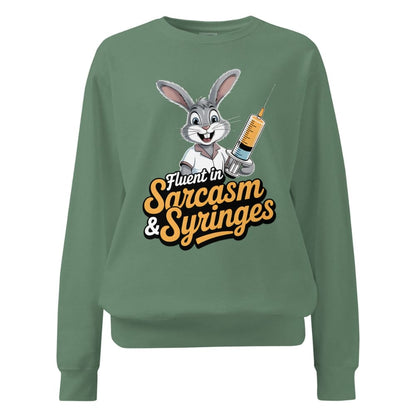 Green sweatshirt with cartoon character and text ' Fluent in Sarcasm & Syringes' on a white background