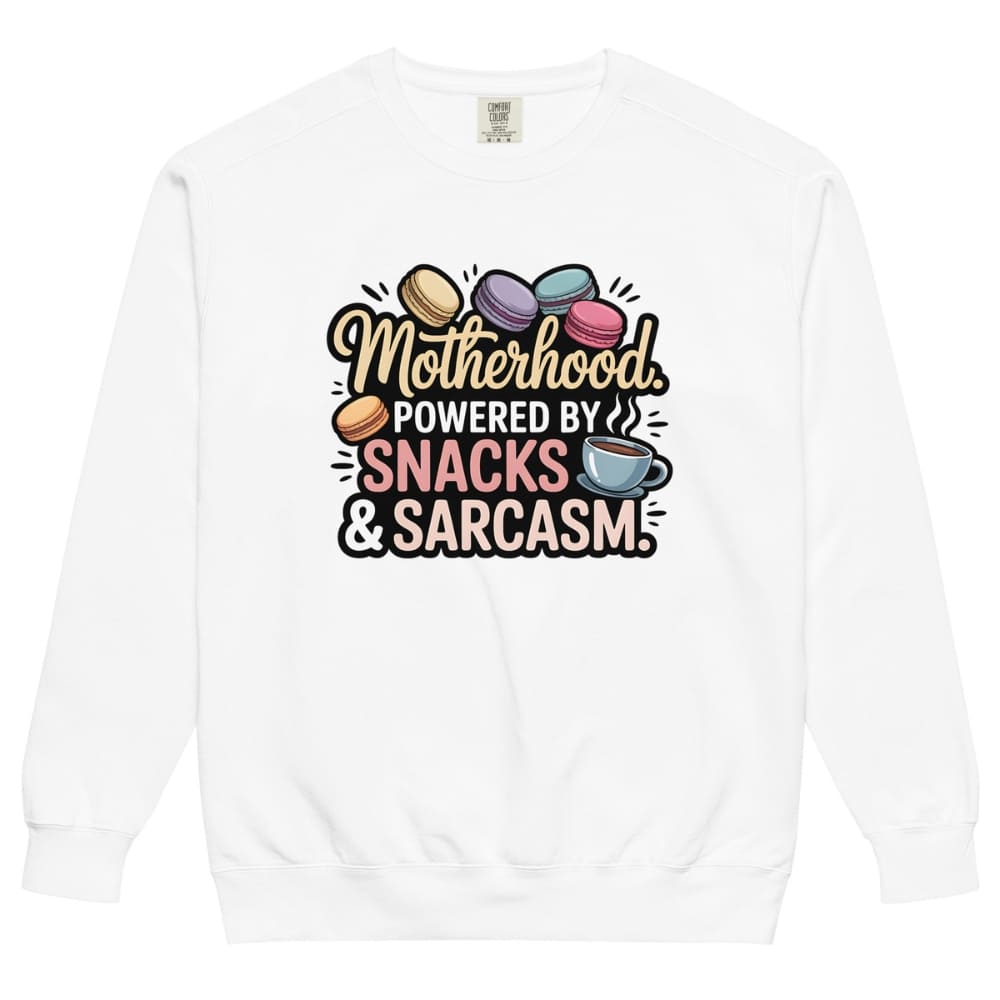 Sweatshirt design with text “Motherhood. Powered by Snacks & Sarcasm.” featuring colorful macarons and a steaming coffee cup on vintage-washed cotton fleece.