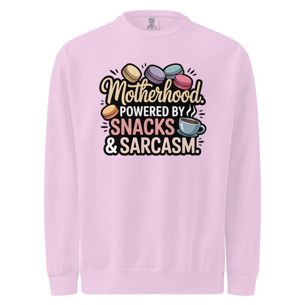 Sweatshirt design with text “Motherhood. Powered by Snacks & Sarcasm.” featuring colorful macarons and a steaming coffee cup on vintage-washed cotton fleece.