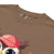 Cute cartoon owl cheerleader holding a pom-pom and clipboard, wearing a red cap with the quote “Behind Every Great Swing Is a Loud Mom” – featured on garment-dyed heavyweight cotton tee
