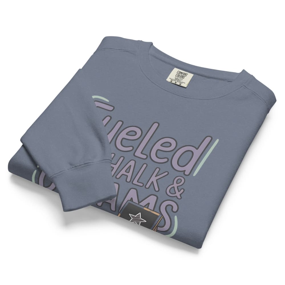 Fueled by Chalk & Dreams printed design on a vintage-style garment-dyed sweatshirt with chalkboard illustration – soft fleece ideal for teachers