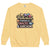 Sweatshirt design with text “Motherhood. Powered by Snacks & Sarcasm.” featuring colorful macarons and a steaming coffee cup on vintage-washed cotton fleece.