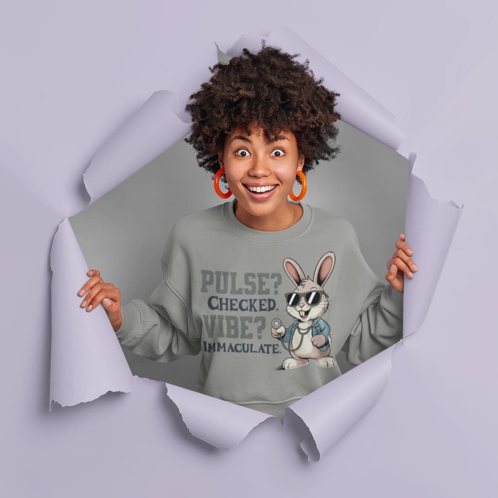 Person wearing a sweatshirt with a cartoon character and text, standing behind a torn paper effect.